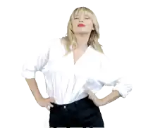 a woman in a white shirt and black pants is dancing