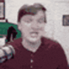 a blurry picture of a man wearing a red shirt .