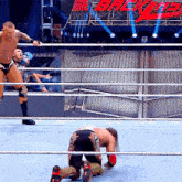 two men are wrestling in a ring with a sign that says backlash