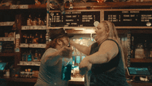 a man and a woman are dancing in front of a sign that says ' ernes bondock '
