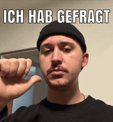 a man giving a thumbs down sign with the words ich hab gefragt behind him