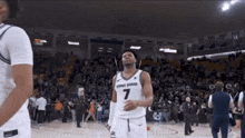 a basketball player with utah state on his shirt