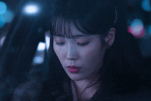 a woman in a car with her eyes closed
