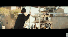 a man in a top hat is playing drums in front of a chinese building