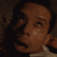 a close up of a man 's face with sweat coming out of it