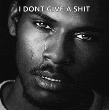a black and white photo of a man crying with the words i dont give a shit below him