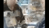 a man is sitting at a table in a restaurant looking at a tablet .