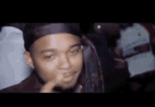 a man is making a funny face in a crowd of people .