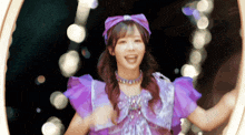 a girl in a purple dress with a purple headband