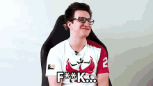a man wearing glasses and a shirt that says f ** k on it