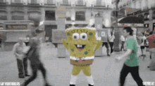a spongebob mascot is dancing in the street