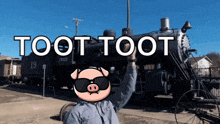 a man wearing sunglasses stands in front of a train with the words toot toot written on it