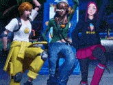 a girl with the word charlie on her face is standing next to two other girls
