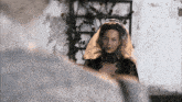 a woman in a black lace dress with a white veil