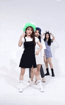 a woman in a black dress is dancing with a group of women .