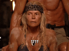 a woman wearing a leopard print headband and a necklace with the question mark on it
