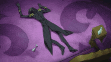 a man in a black suit is laying on a purple surface