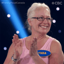 a woman with glasses and a name tag that says ynda