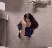 a woman wearing a blue shirt with the word me on it