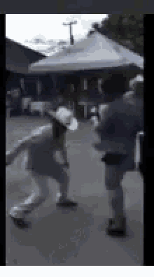 a blurry picture of a man in a cowboy hat walking down a street