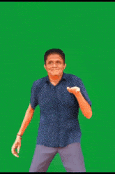 a man in a polka dot shirt is covering his face with his hand