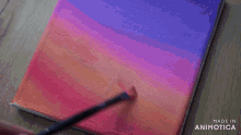 a person is using a brush to paint a sunset on a canvas made in animatica