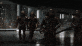 two men in armor are standing next to each other in a room .