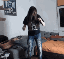 a woman is dancing in front of a poster that says e.d.h. tiger