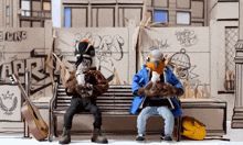 two cartoon characters sitting on a bench in front of a wall with graffiti that says r.o.r.s.