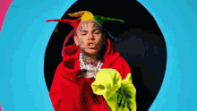 a man wearing a red hoodie with the number 69 on his head