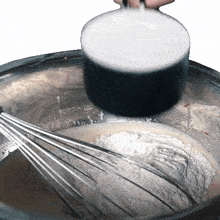 pouring flour two plaid aprons adding ingredients baking preparing food