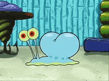 a cartoon character from spongebob squarepants is crawling on the sand