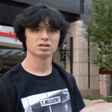 a man wearing a black shirt that says 1 million on it