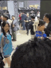 a woman in a costume stands in a crowd