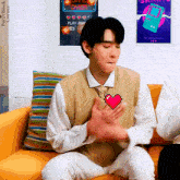 a man wearing a vest with a pixel heart on it