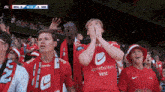 a group of people wearing red shirts with the word sparebanken vest on them