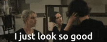 a woman looking at herself in a mirror with the words " i just look so good "