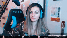 a woman wearing headphones sitting in front of a microphone