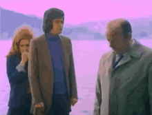 a man in a suit and tie is standing next to a woman