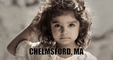 a little girl in a white dress with the words chelsford ma on the bottom