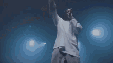 a man singing into a microphone on a stage