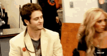 a man and a woman are standing next to each other with rbd.gif written on the bottom