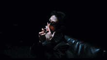 a painting of a man smoking a cigarette with a lighter in his hand