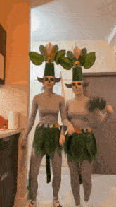 two women dressed in costumes with plants on their heads