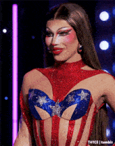 a drag queen wearing a red white and blue dress with stars