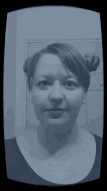 a black and white photo of a woman with two buns on her head