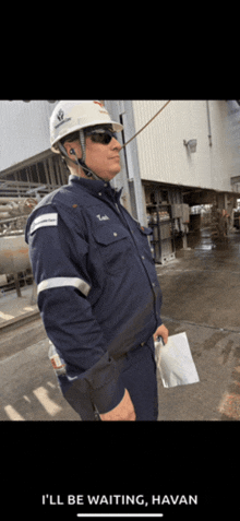 a man wearing a hard hat and sunglasses says i 'll be waiting