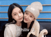 two girls are posing for a picture and the caption says athiliv