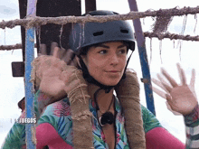 a woman wearing a helmet and a shirt that says juegos on it