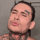 a man with 666 tattooed on his forehead
